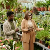 Woman choosing plants with landscape designer